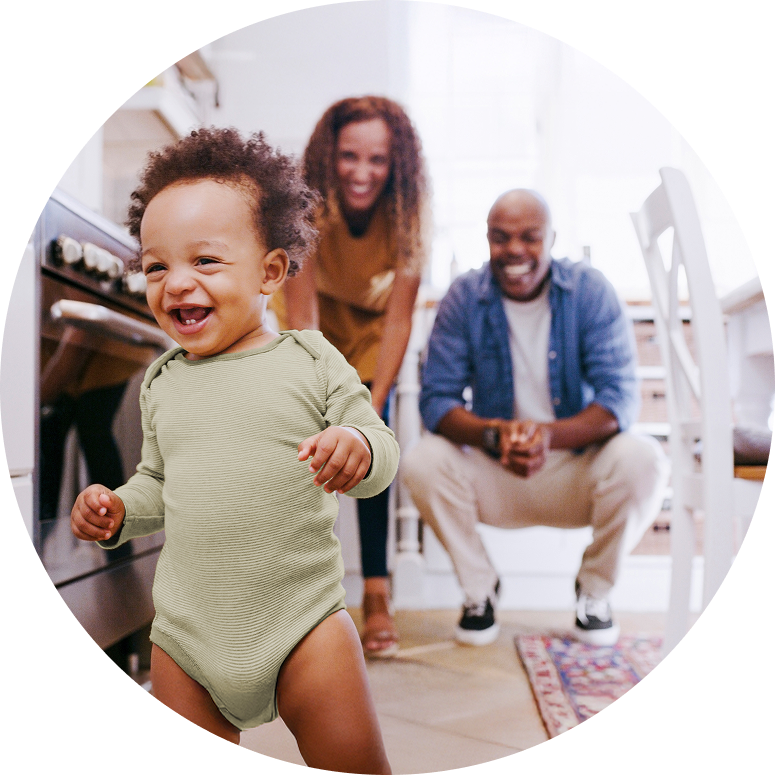 Proud parents watching their toddler explore